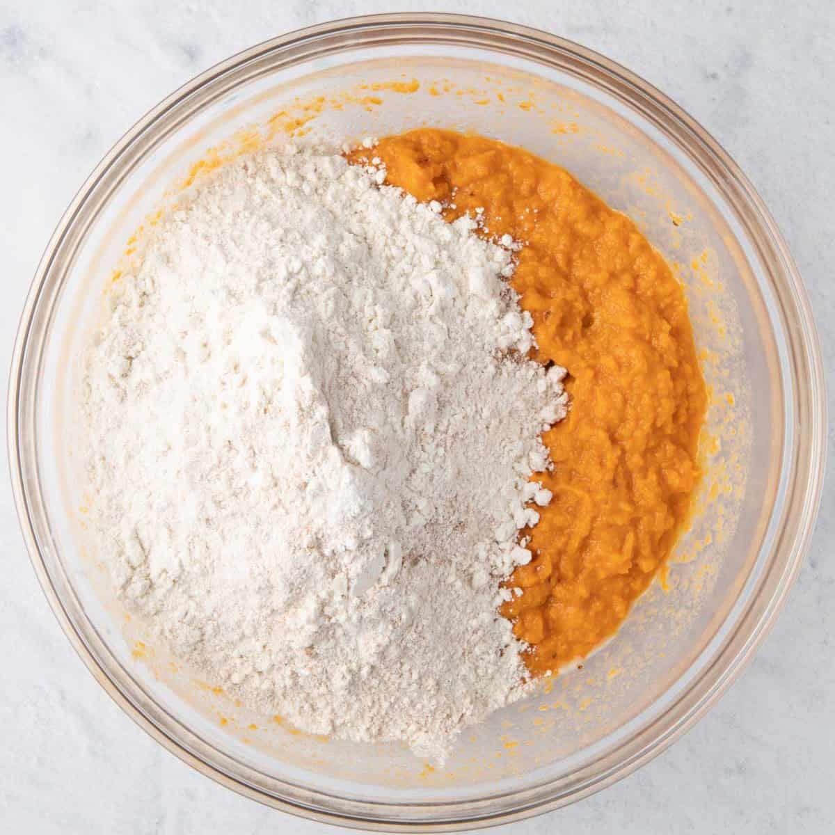 Mixed dry ingredients added on top/side of the sweet potato mixture before mixing.