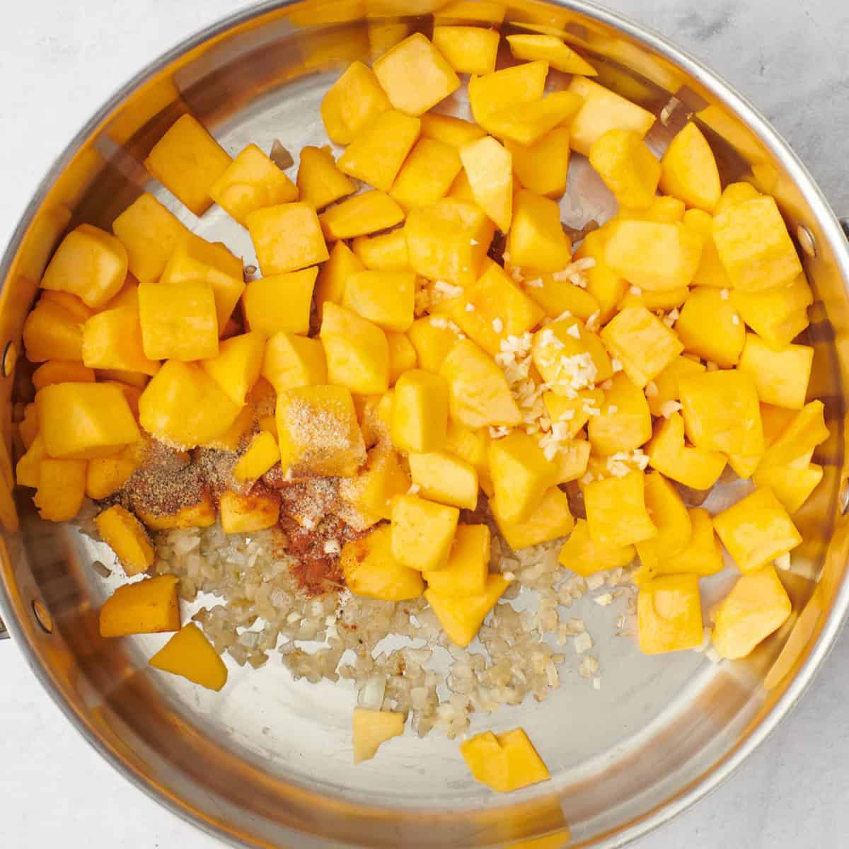 Butternut squash cubes, garlic and seasonings added before mixing.