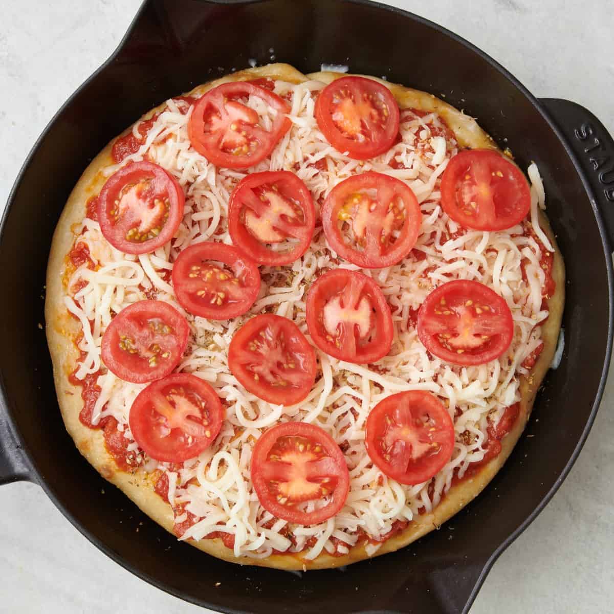 Cheese and toppings added before baking.