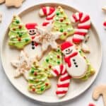 Christmas sugar cookies on a round plate.