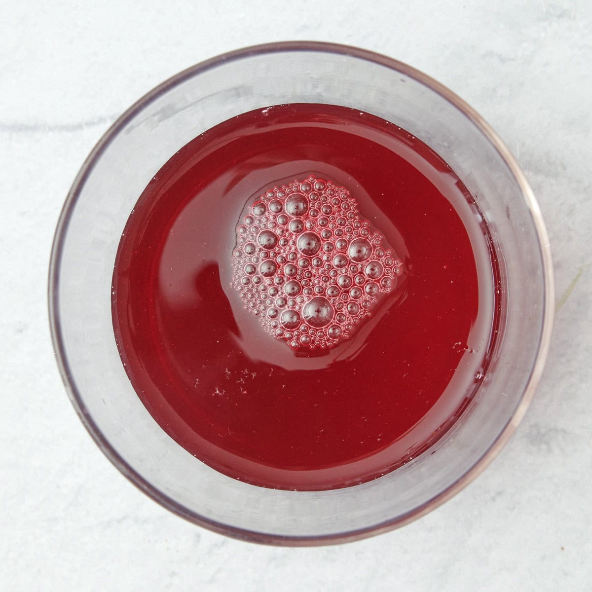 Cranberry juice added to one cup.
