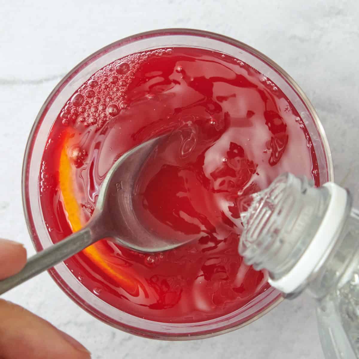 Stirring in club soda.