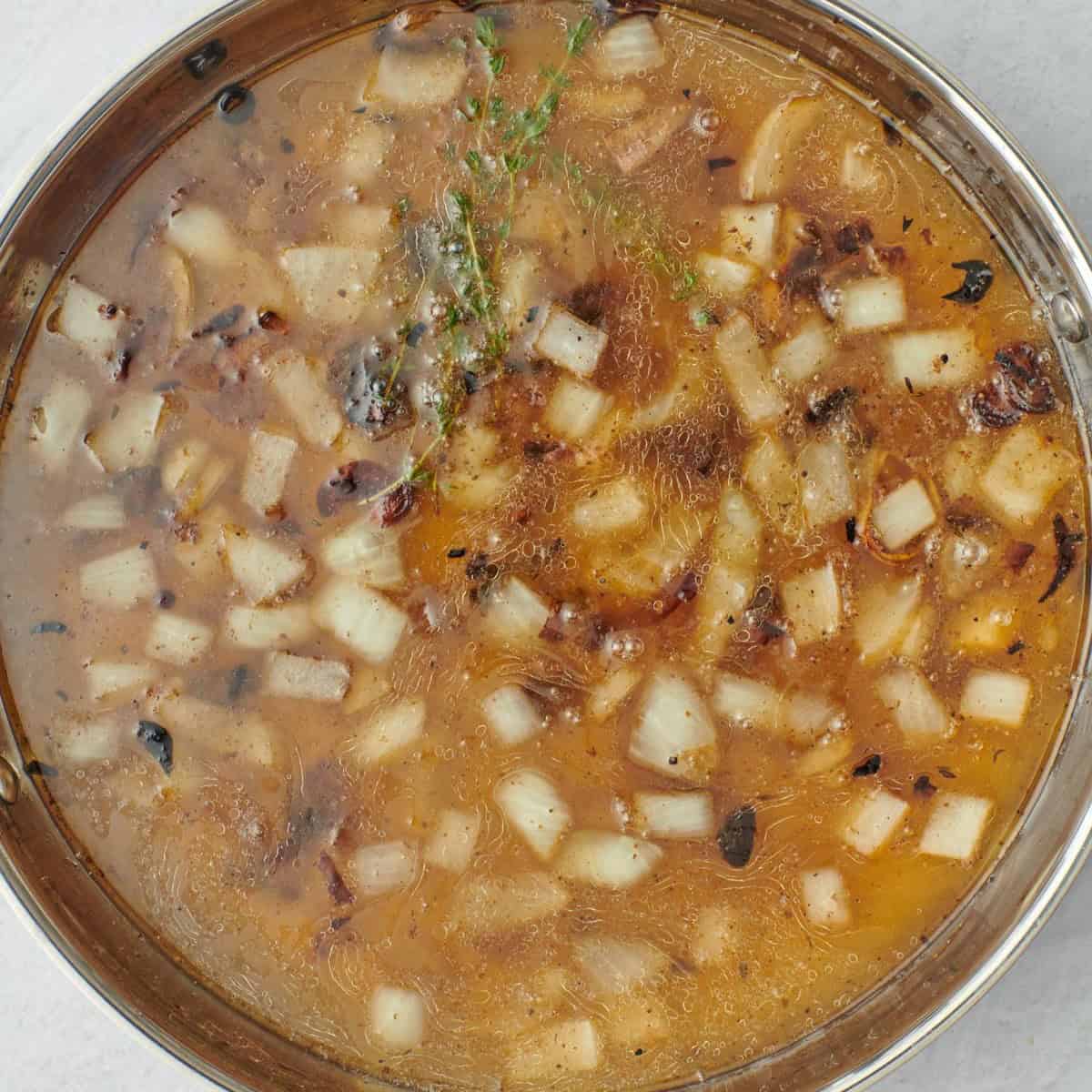 After onions begin to soften with stock and thyme added.