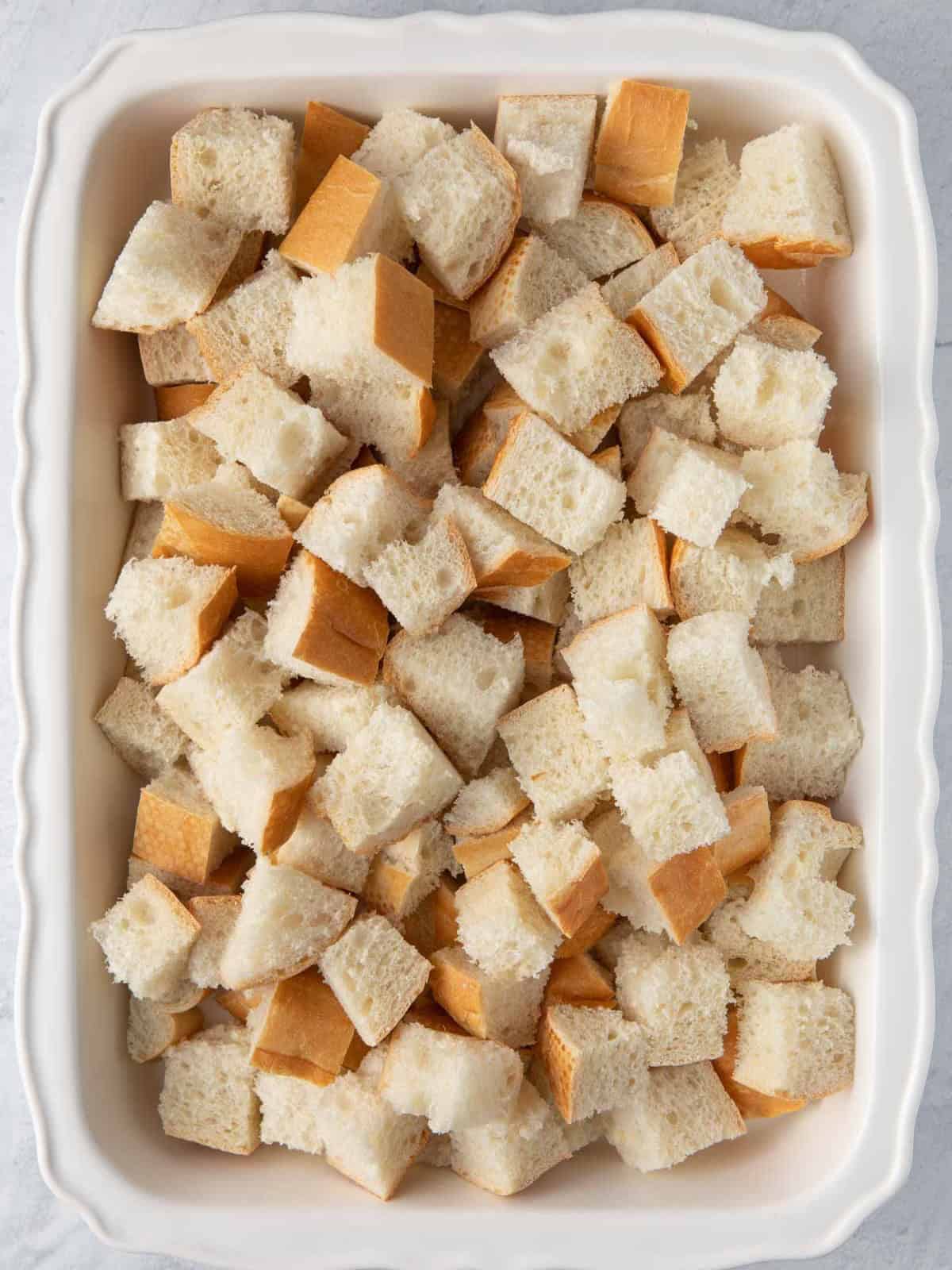French toast cubes in greased baking dish.