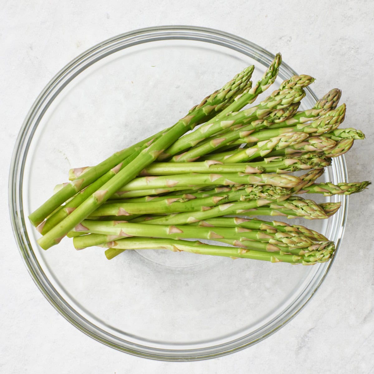 Trimmed asparagus in a large bowl.