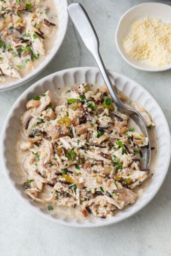 Two bowls of Instant pot chicken and wild rice with focus on one.