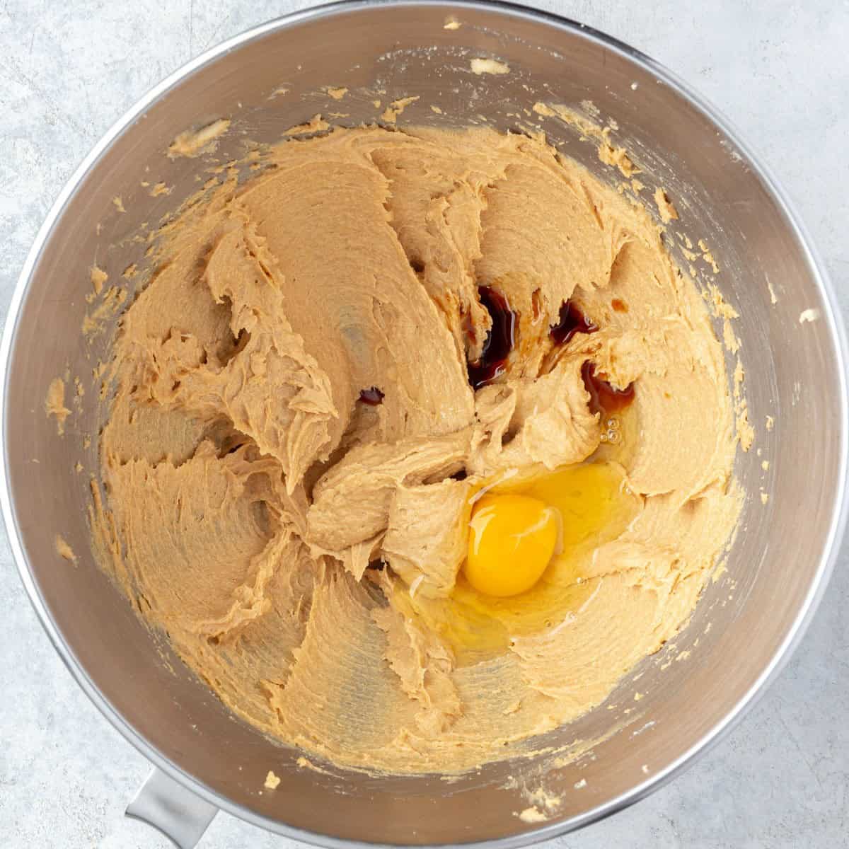 After the peanut butter is incorporated with egg and vanilla added before mixing.