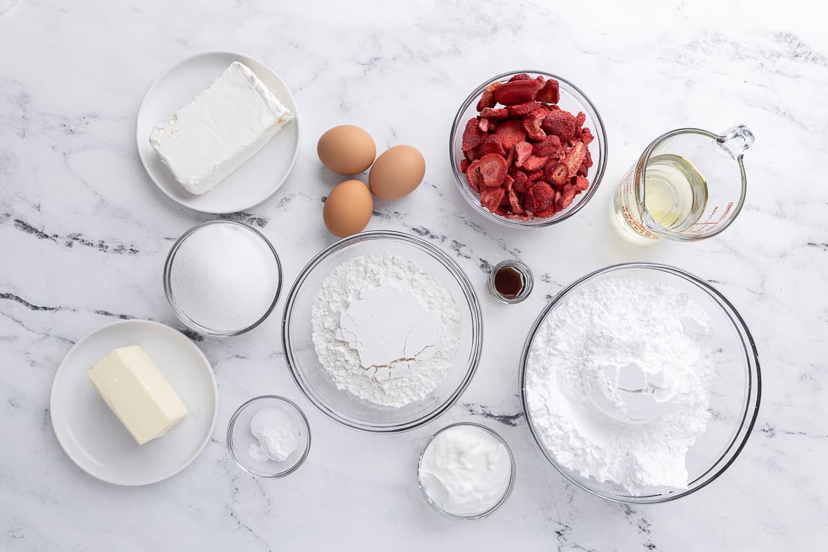 Ingredients for recipe: flour, baking powder, salt, freeze-dried strawberries, eggs, granulated sugar, vanilla extract, vegetable oil, Greek yogurt, cream cheese, and powdered sugar.