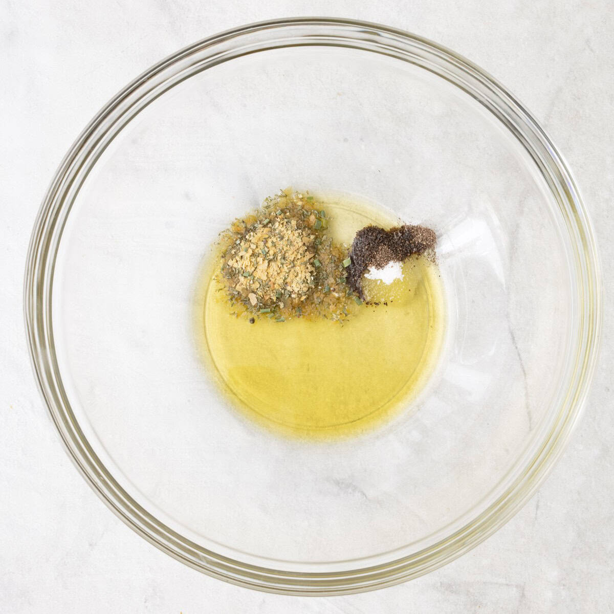 Oil, ranch, salt and pepper in a bowl before mixing.