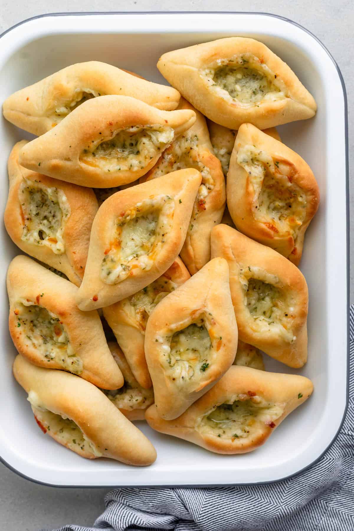 Golden brown cheese fatayer in a rectangular dish.