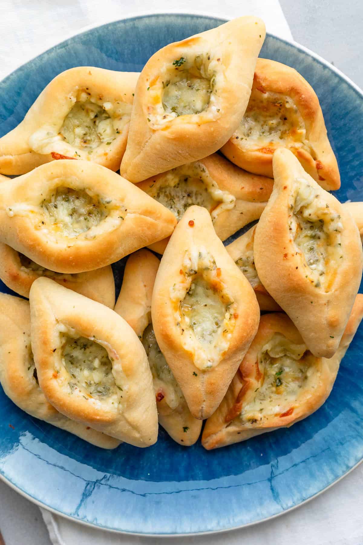 Cheese fatayer piled in a bowl.