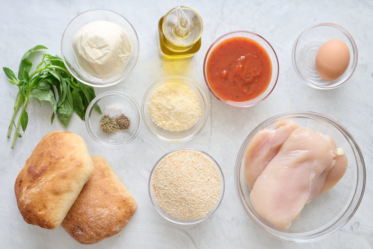 Ingredients to make sandwiches: Chicken cutlets, ciabatta rolls, breadcrumbs, Parmesan cheese, marinara sauce, egg, fresh mozzarella, olive oil, salt, black pepper, Italian seasoning, fresh basil.