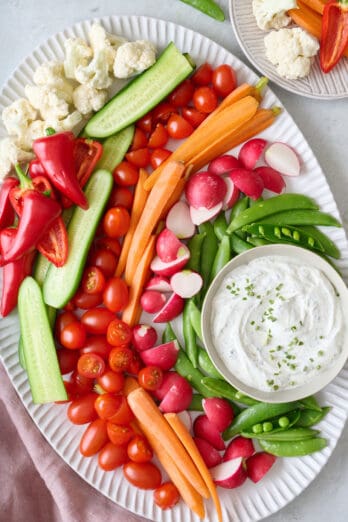 Crudite platter with veggies arranged around dip bowl.