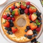 Homemade angel food cake topped with fresh berries.