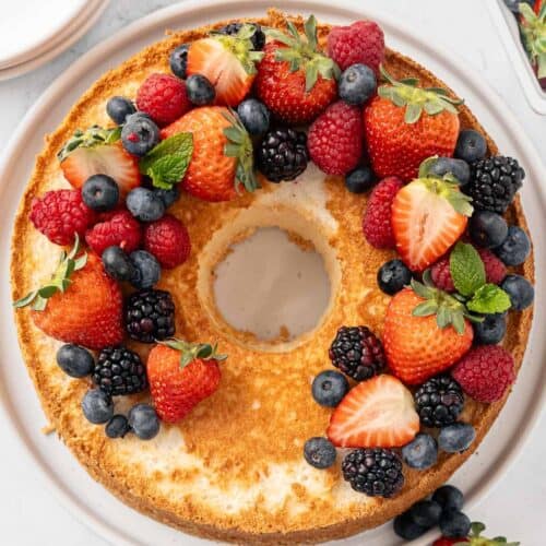 Homemade angel food cake topped with fresh berries.