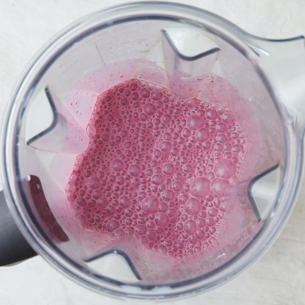 Cherry smoothie ingredients in blender after blending