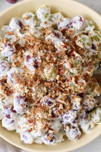 Closeup of grape salad in a bowl with chopped pecans.