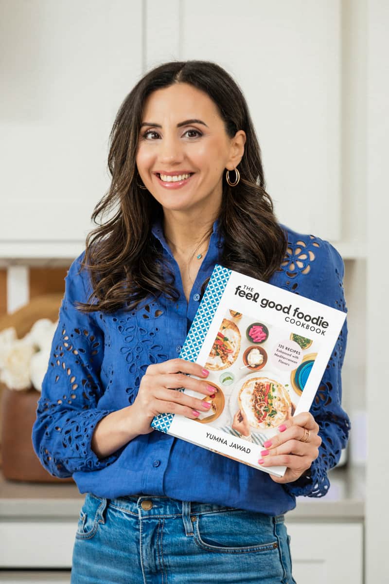 Yumna holding the Feel Good Foodie Cookbook