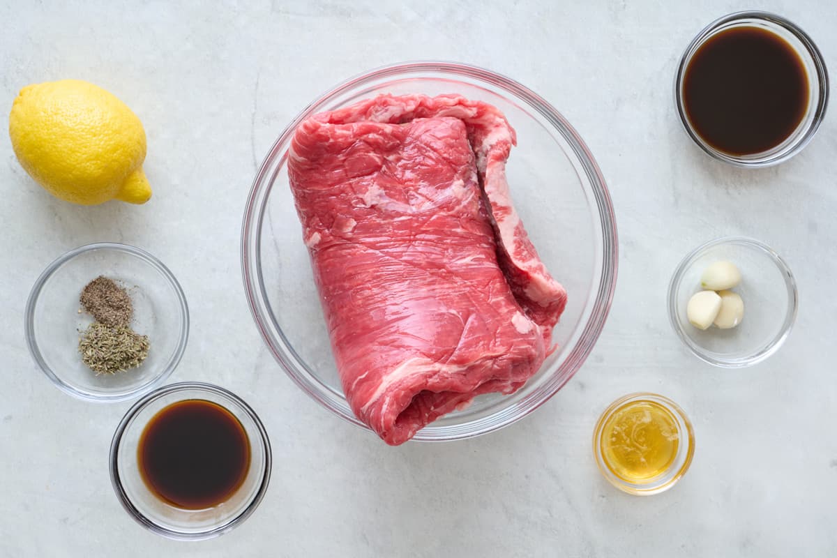 Ingredients for recipe: flank steak, lemon spices, Worcestershire sauce, oil, garlic, and tamari.