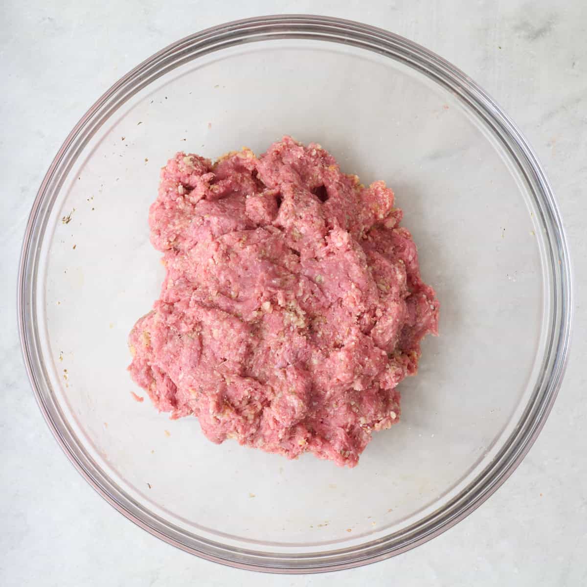 Meatball ingredients in a bowl after combining.