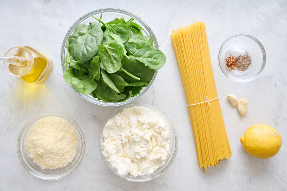 Lemon ricotta pasta ingredients on a marble countertop.