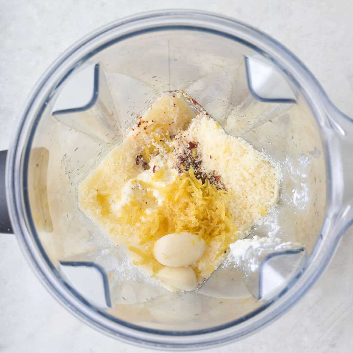 Lemon ricotta pasta sauce ingredients in a blender.