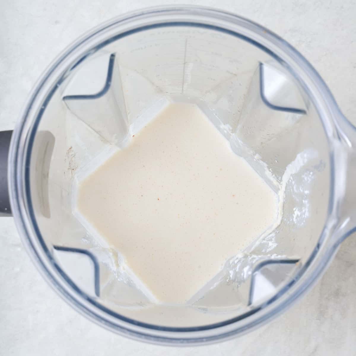 Creamy lemon ricotta sauce in a blender.