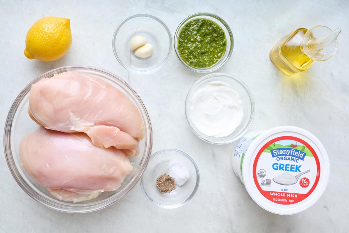 Ingredients for recipe: chicken breasts, Stonyfield Organic Whole Milk Greek Yogurt in tub and small dish, pesto, garlic, lemon, oil, salt ad pepper.