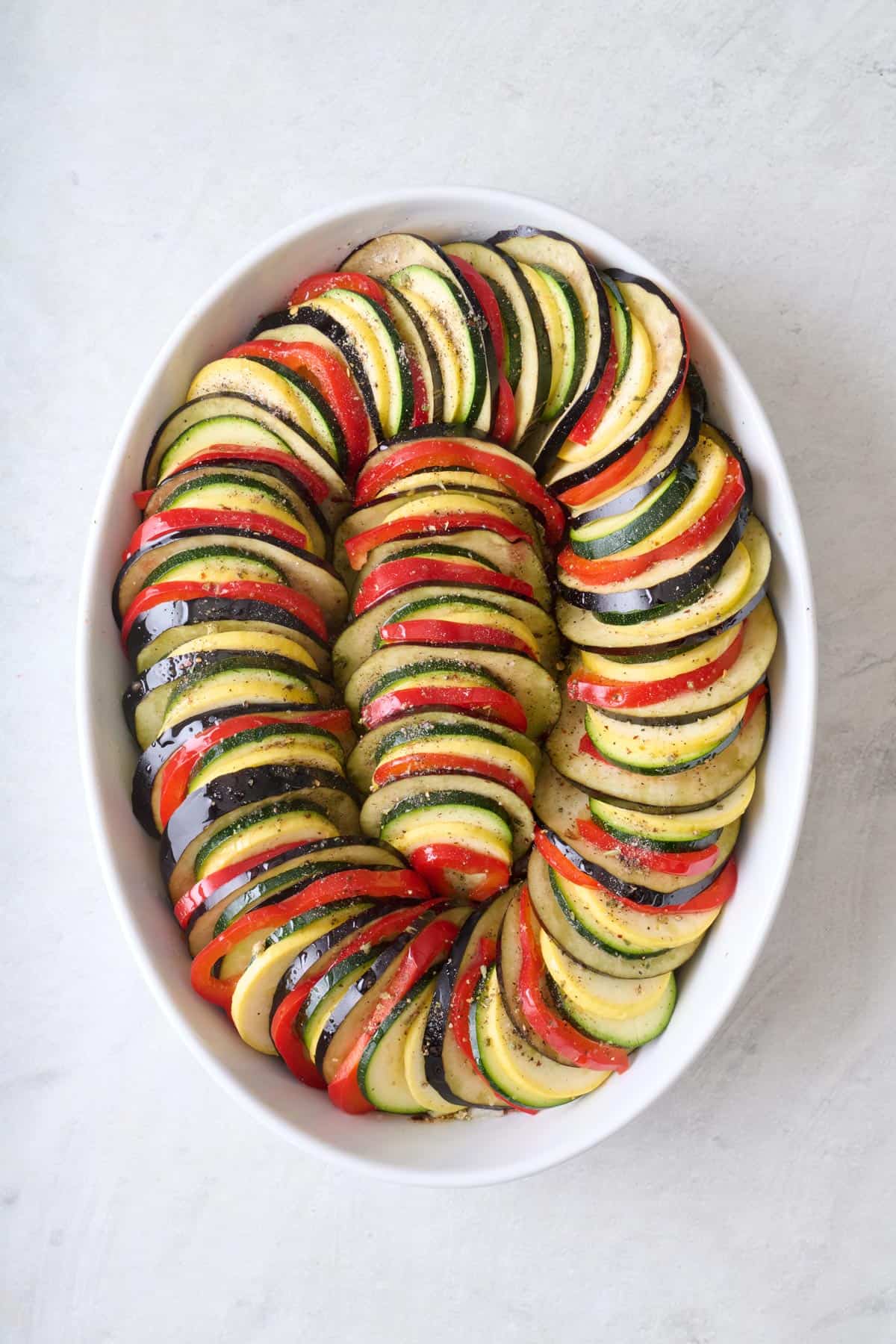 After dish is full with oil and remaining seasonings added, before baking.