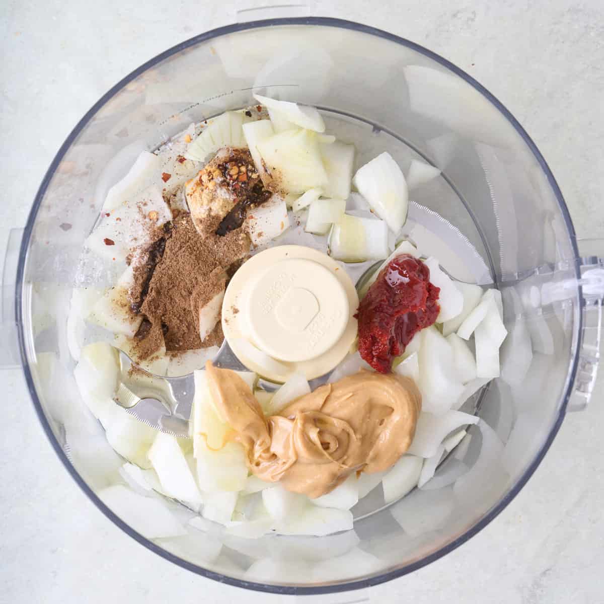 Ingredients for marinade in the bowl of a food processor before processing.