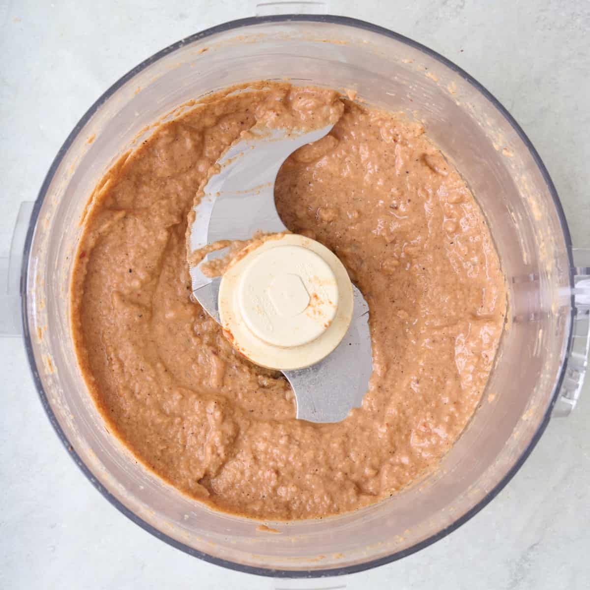 Steak marinade after blending into a smooth paste in the bowl of a food processor.
