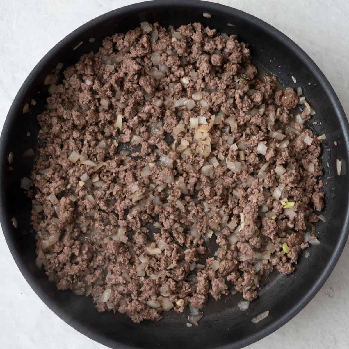 Cooked ground beef mixture in skillet.