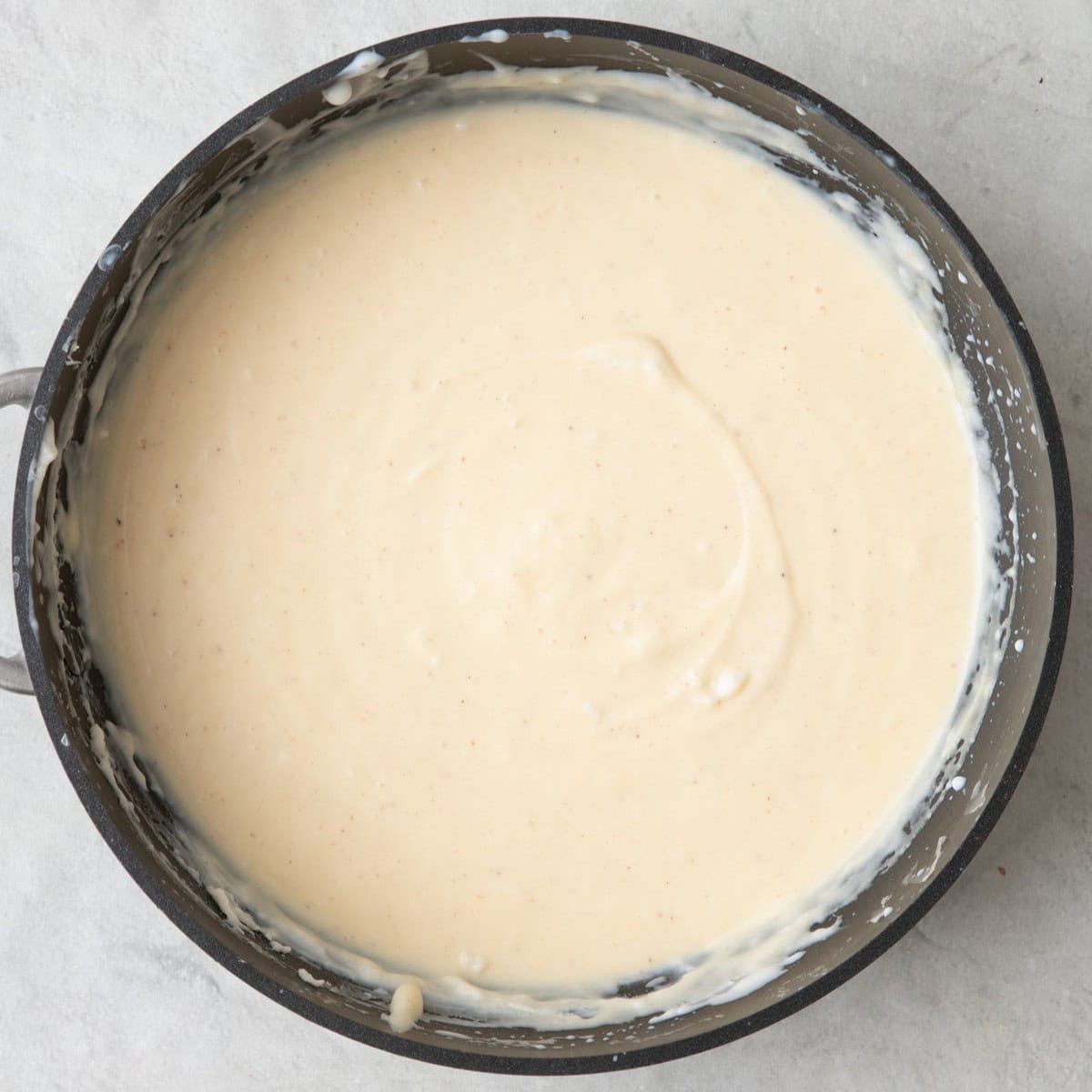 Egg mixture whisked into bechamel saucepan to show final texture.