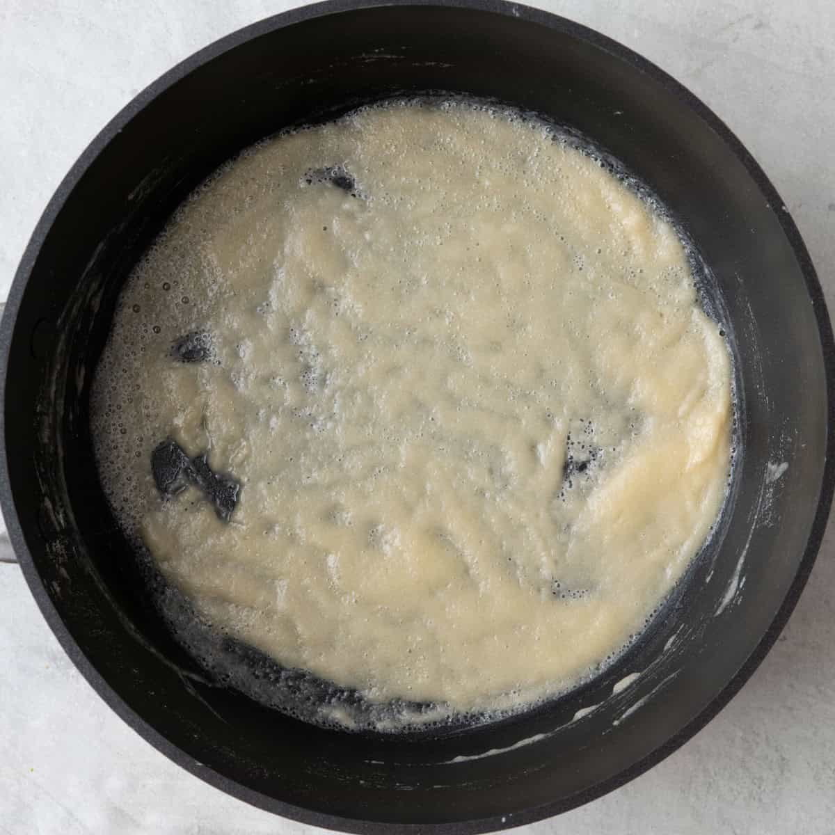 Butter and flour mixture after cooking, showing bubbly flour.