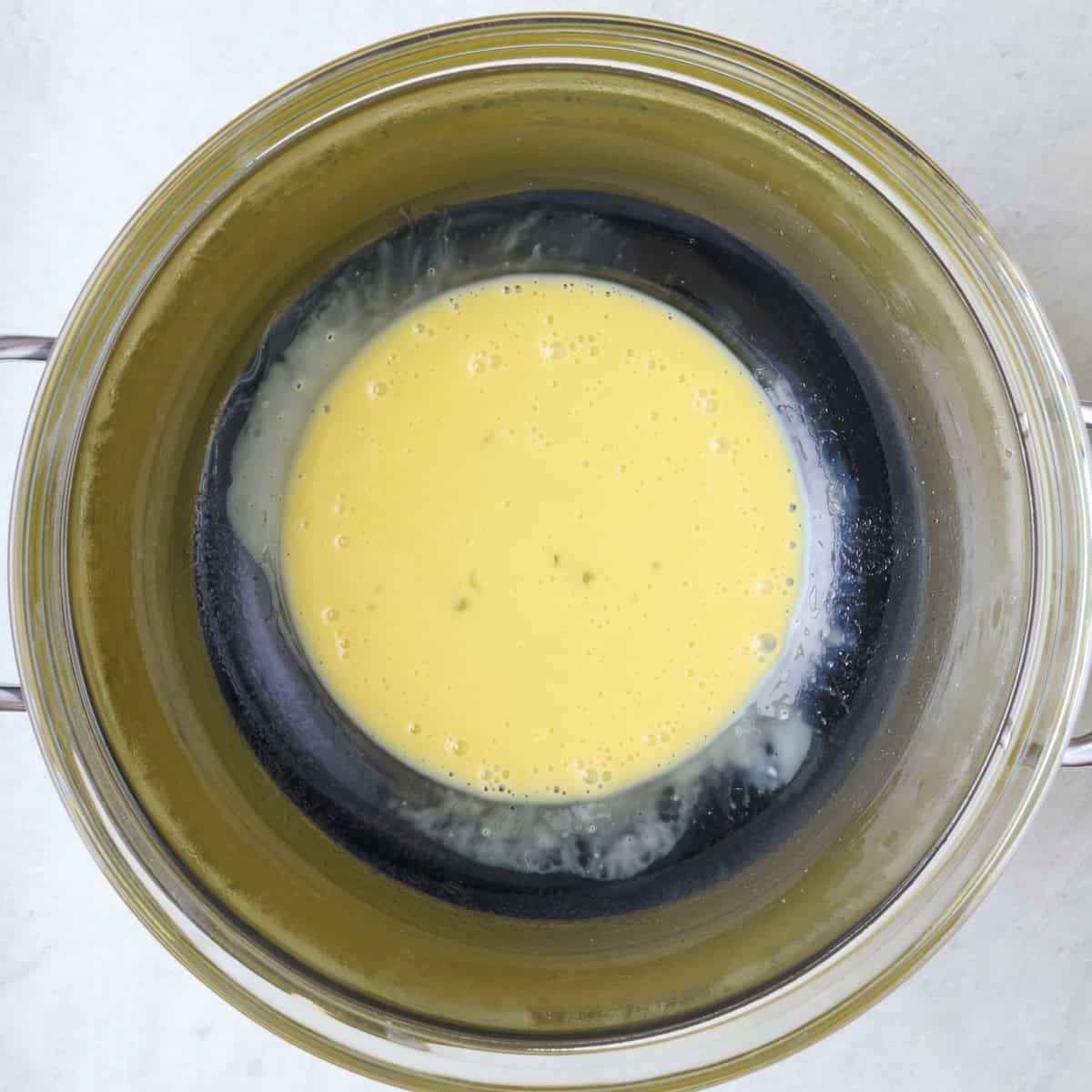 After whisking eggs, lemon juice, and water together before cooking.