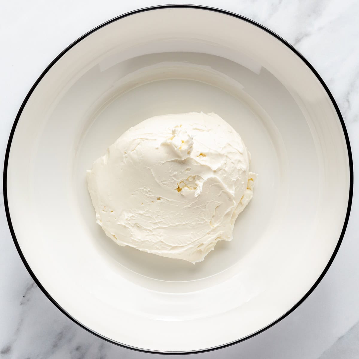 Cream cheese in a mixing bowl.