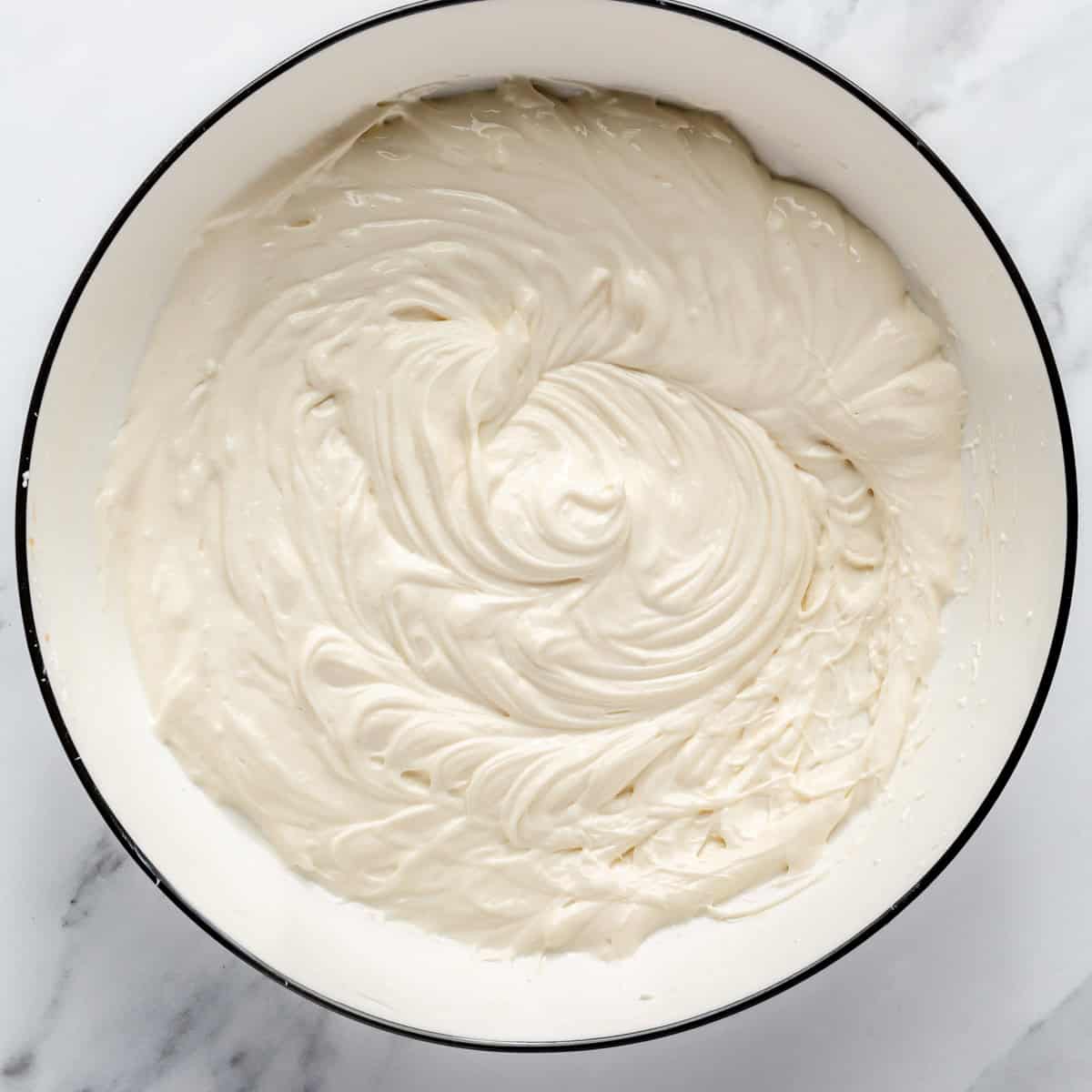 Cream cheese-yogurt mixture in a mixing bowl.