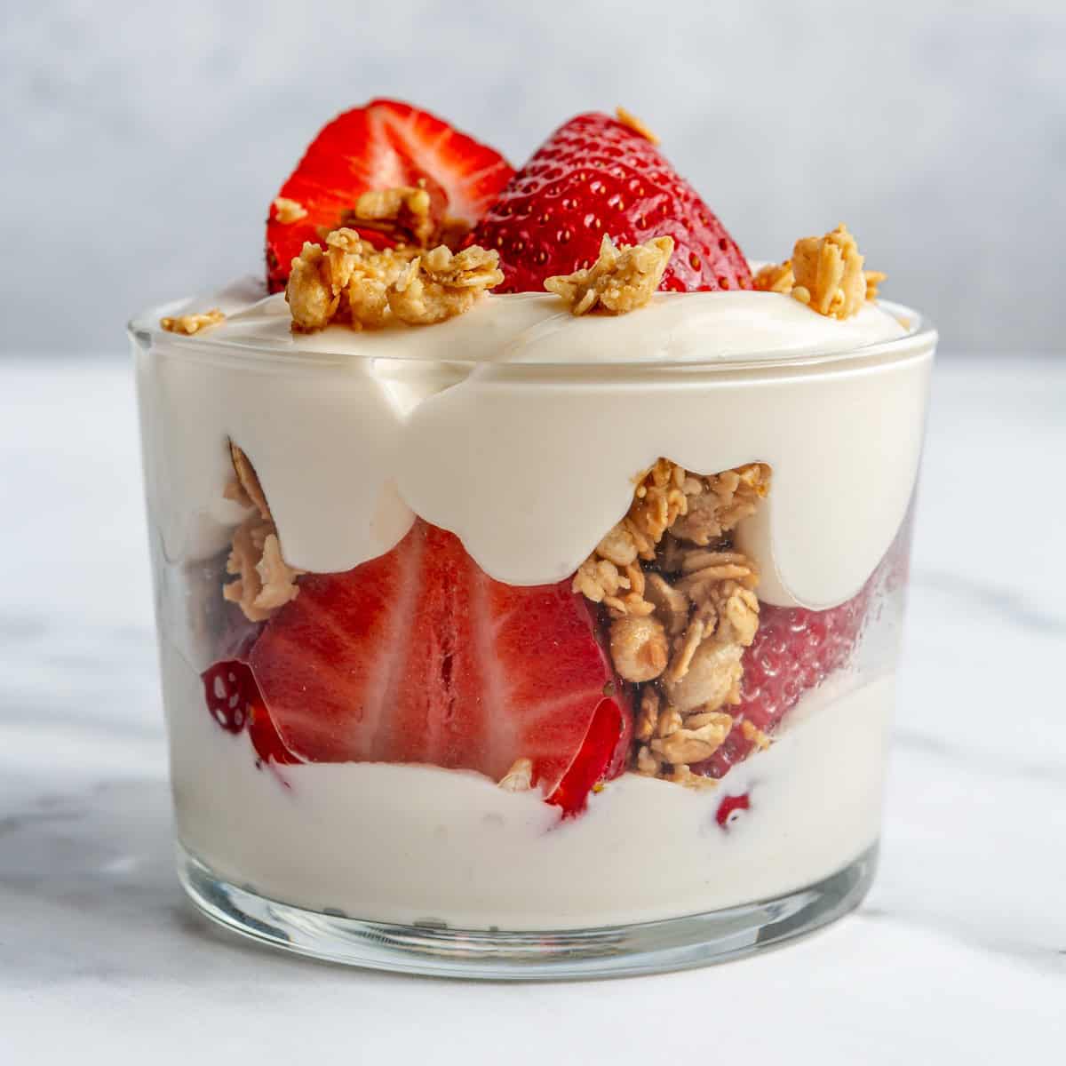 A strawberry parfait in a mixing glass.