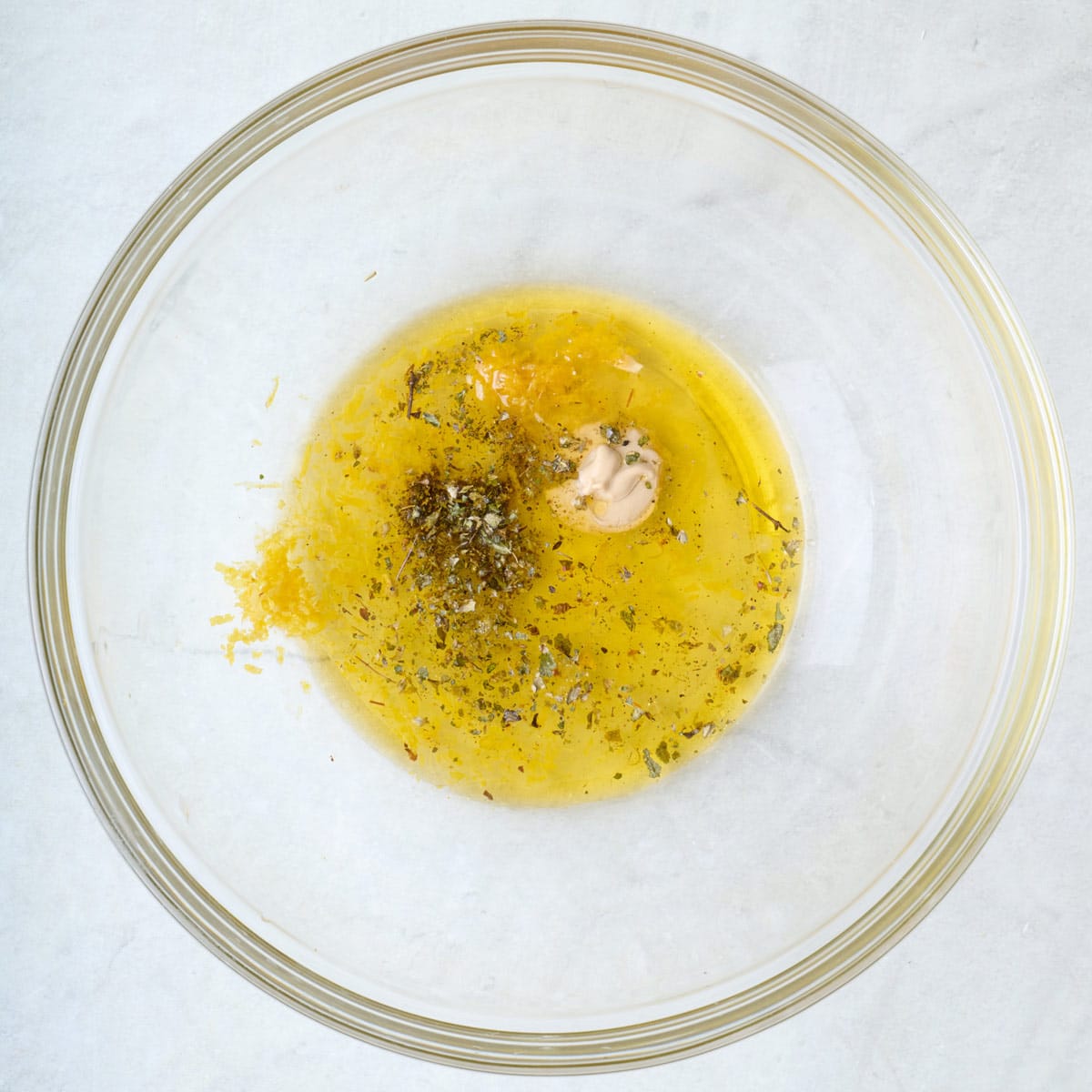 Dressing ingredients in a bowl before mixing.