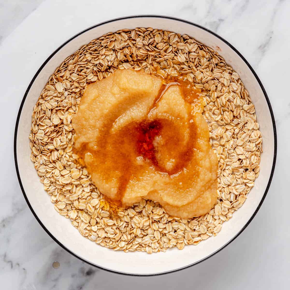 Applesauce and maple syrup added on top of oat mixture.