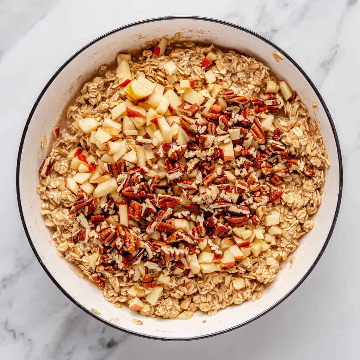 Chopped apples and pecans on top of muffin mixture.