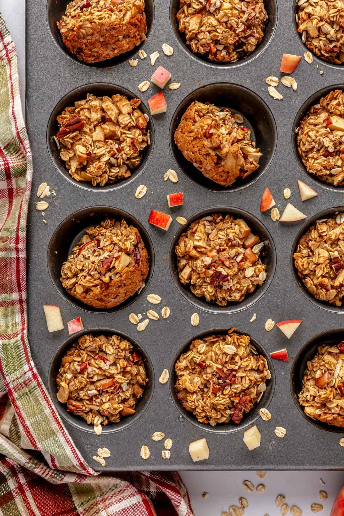 Apple cinnamon oatmeal cups in a muffin tray.