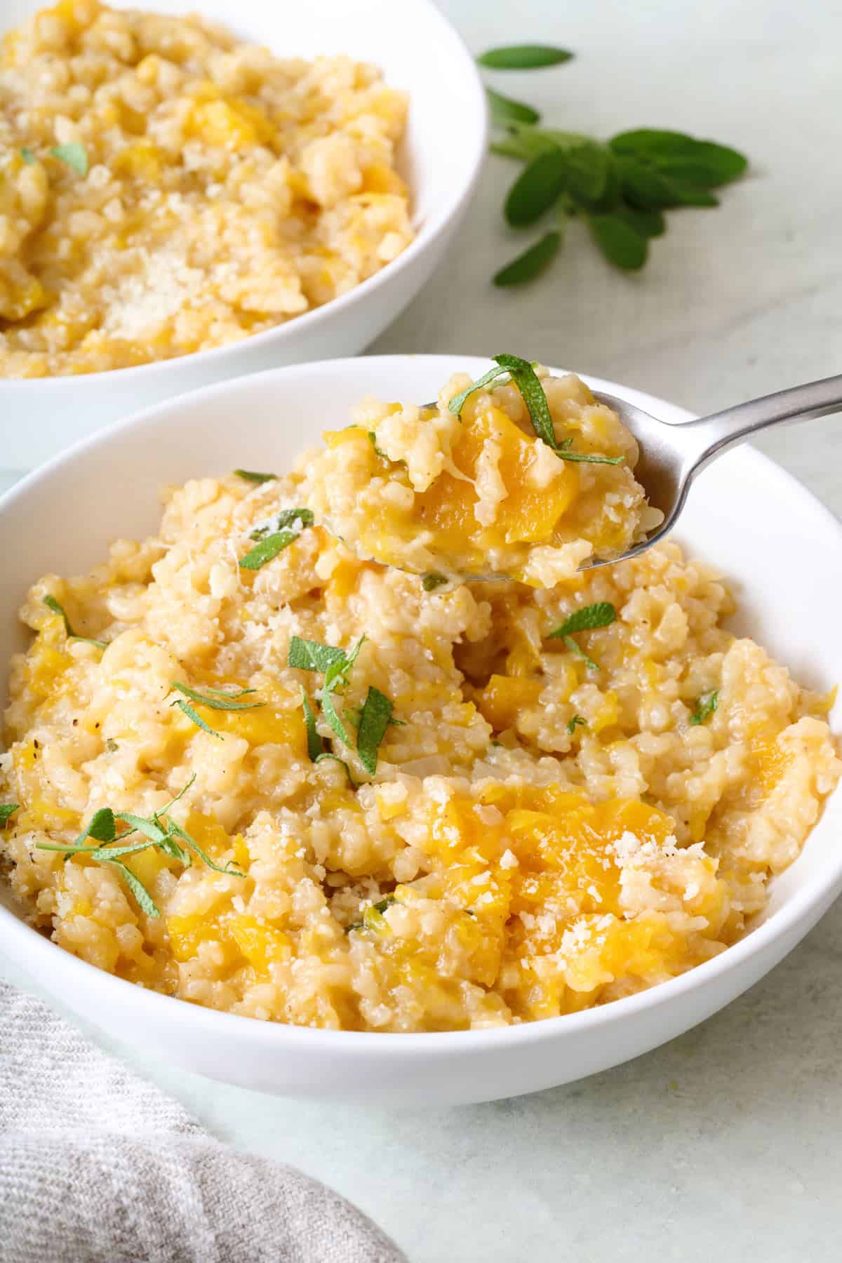 Spoon lifting up a bite of butternut squash risotto.