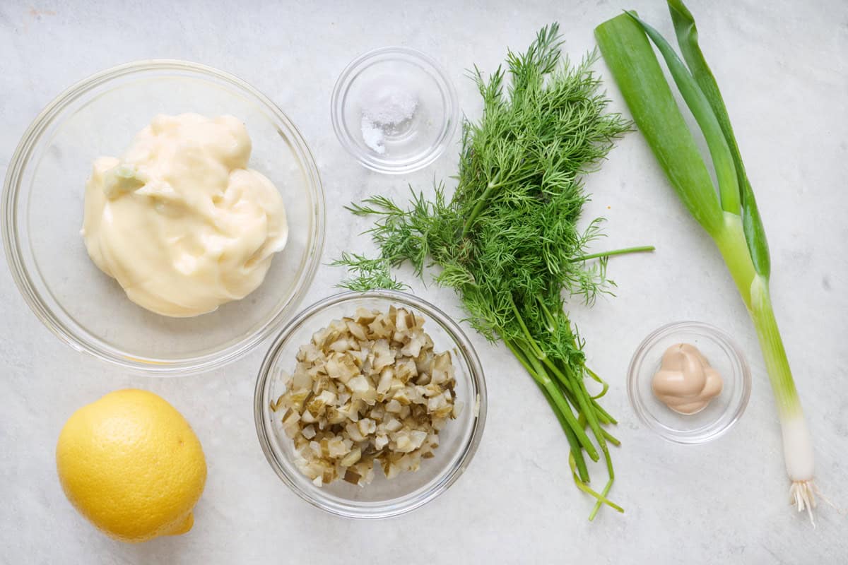 Ingredients for recipe: mayo, chopped dill pickles, green onion, fresh dill, lemon juice, Dijon mustard, and salt.
