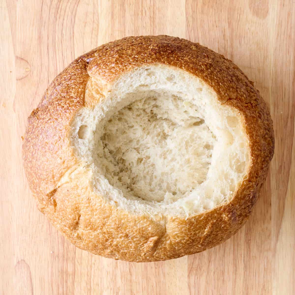 Bread after cutting a circle out and scooping out the bread.
