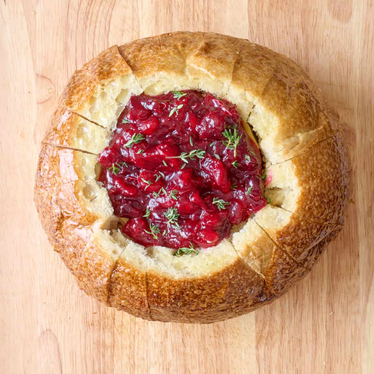 Cranberry sauce added on top with fresh rosemary before baking.