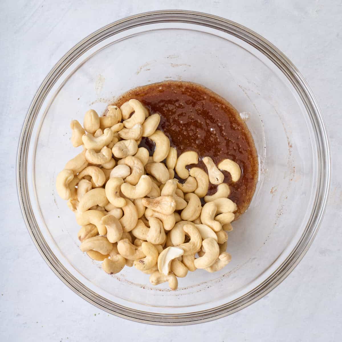 After stirring melted butter mixture together with raw cashews added on top.
