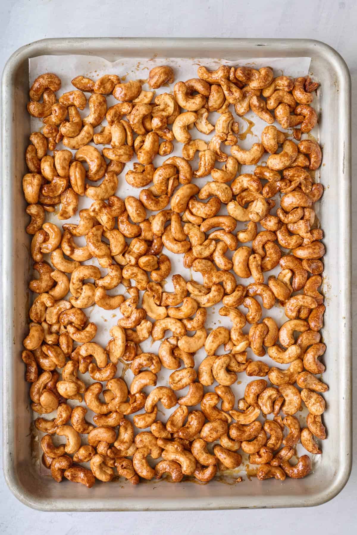 Sweet roasted nuts on baking sheet.