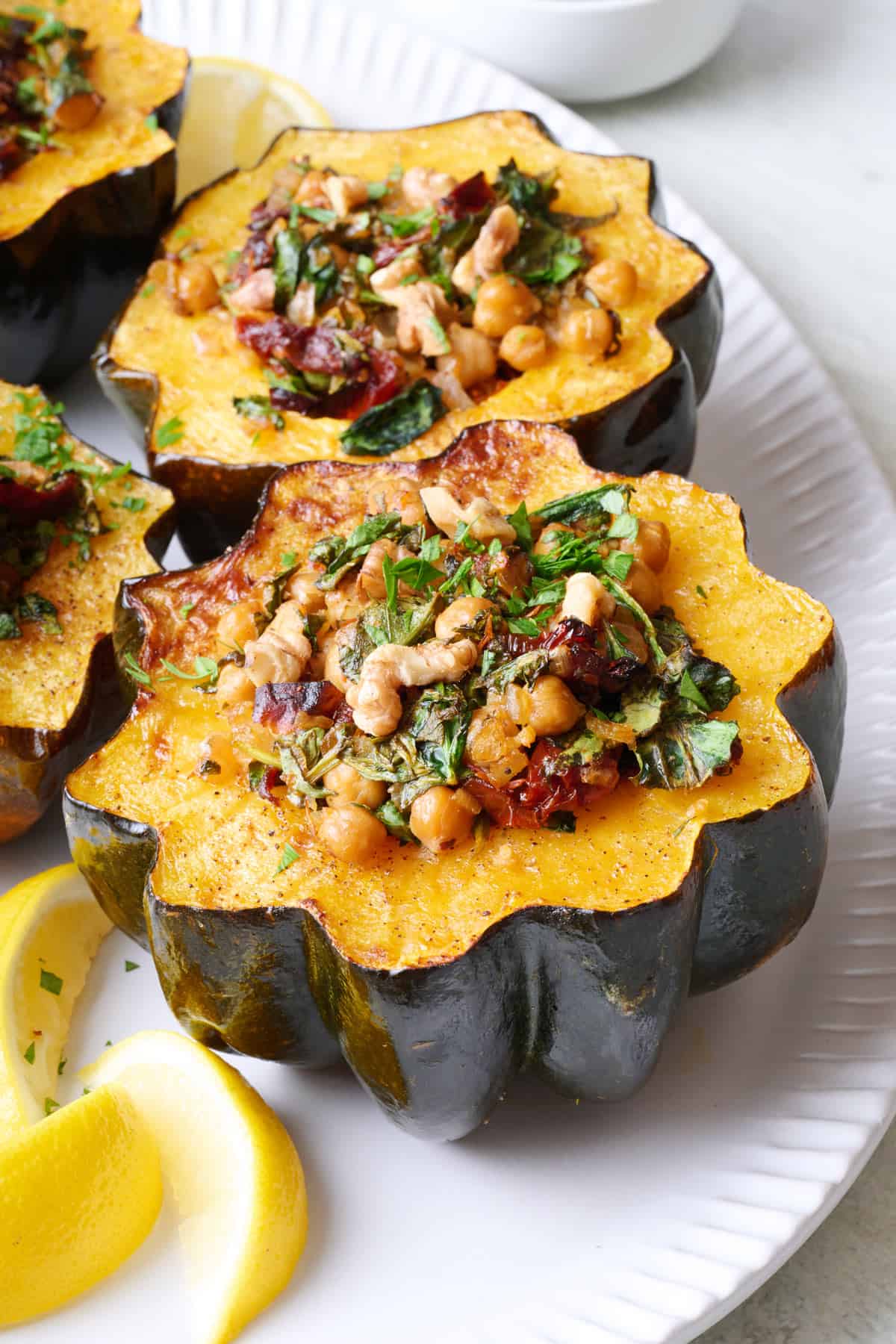 Mediterranean stuffed acorn squash on platter.