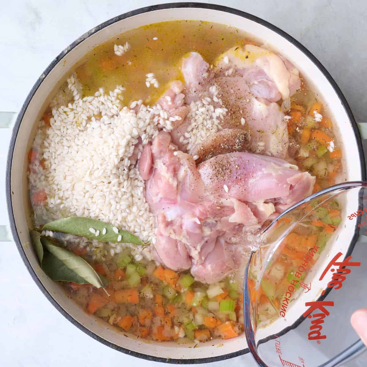 Rice added with water being poured in.